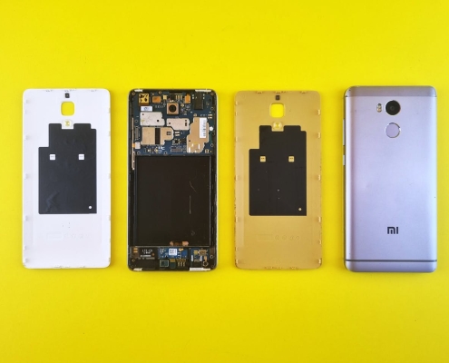 Dismantled Smartphone on Yellow Surface