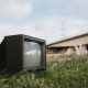 Vintage TV set on grassy seashore